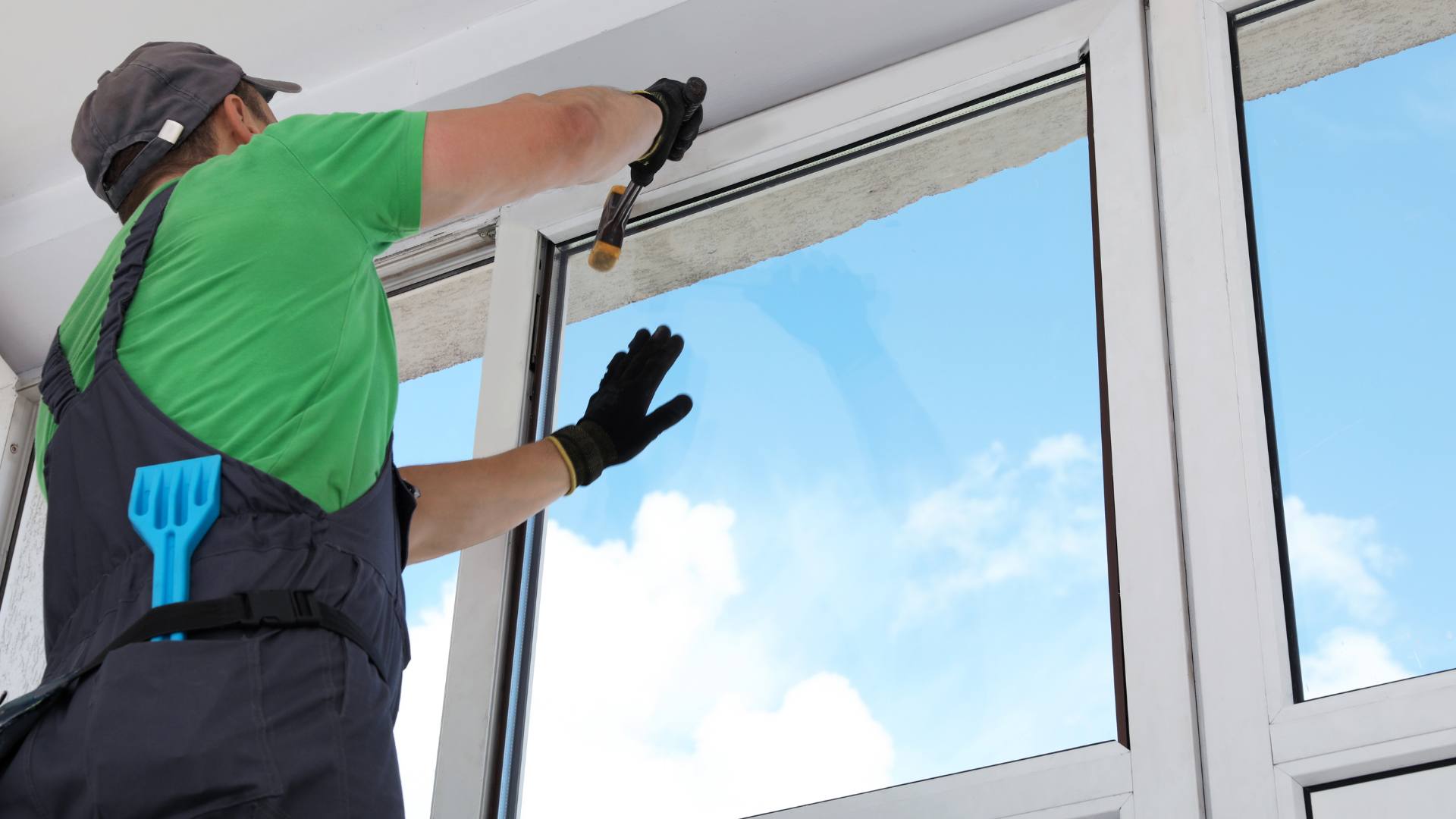 Worker cleaning a large window with a squeegee